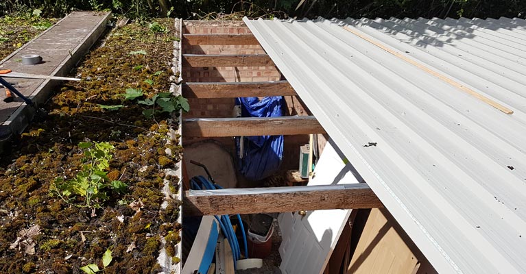 Asbestos cement roof panels in Sutton Coldfield being removed.