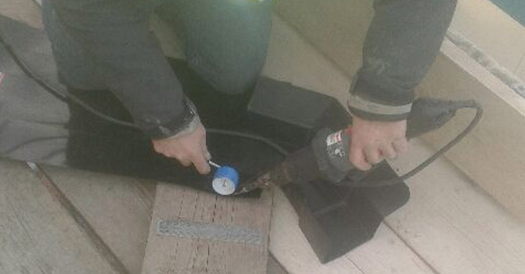 Plygene specialist using a heat gun and roller