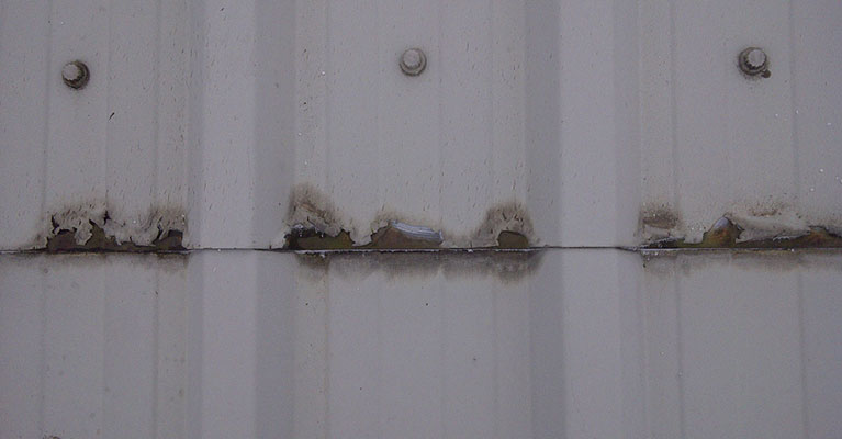 Plastisol coating peeling away from the industrial roof