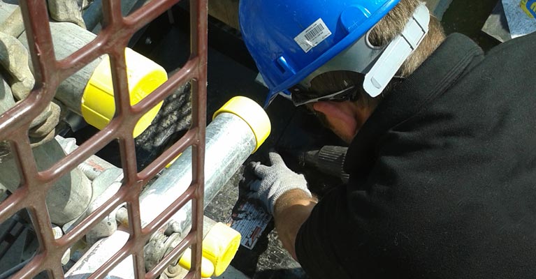Heat welding the Plygene stop end using a heat gun and seam roller