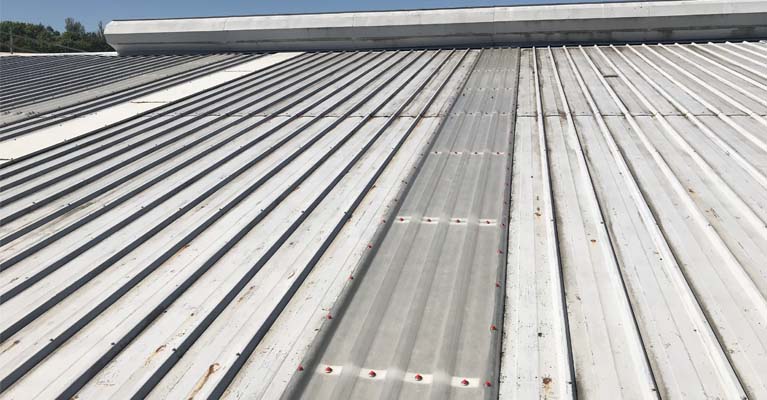 GRP roof lights installed and fixed down with poppy red fixings.
