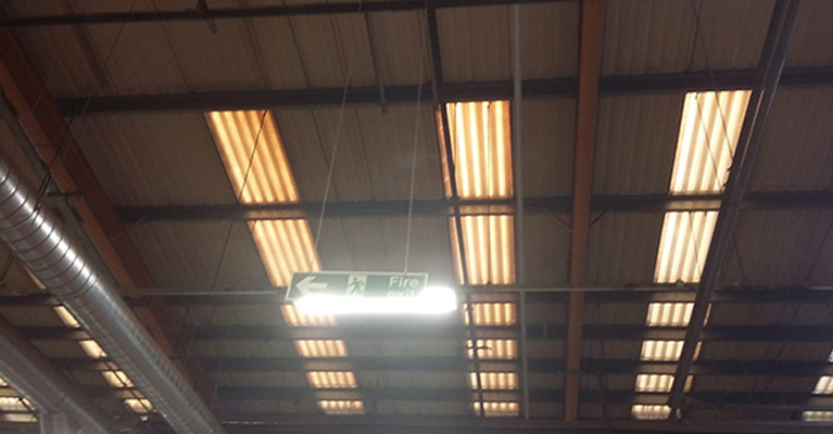 Internal view looking up at the dilapidated old grp rooflights